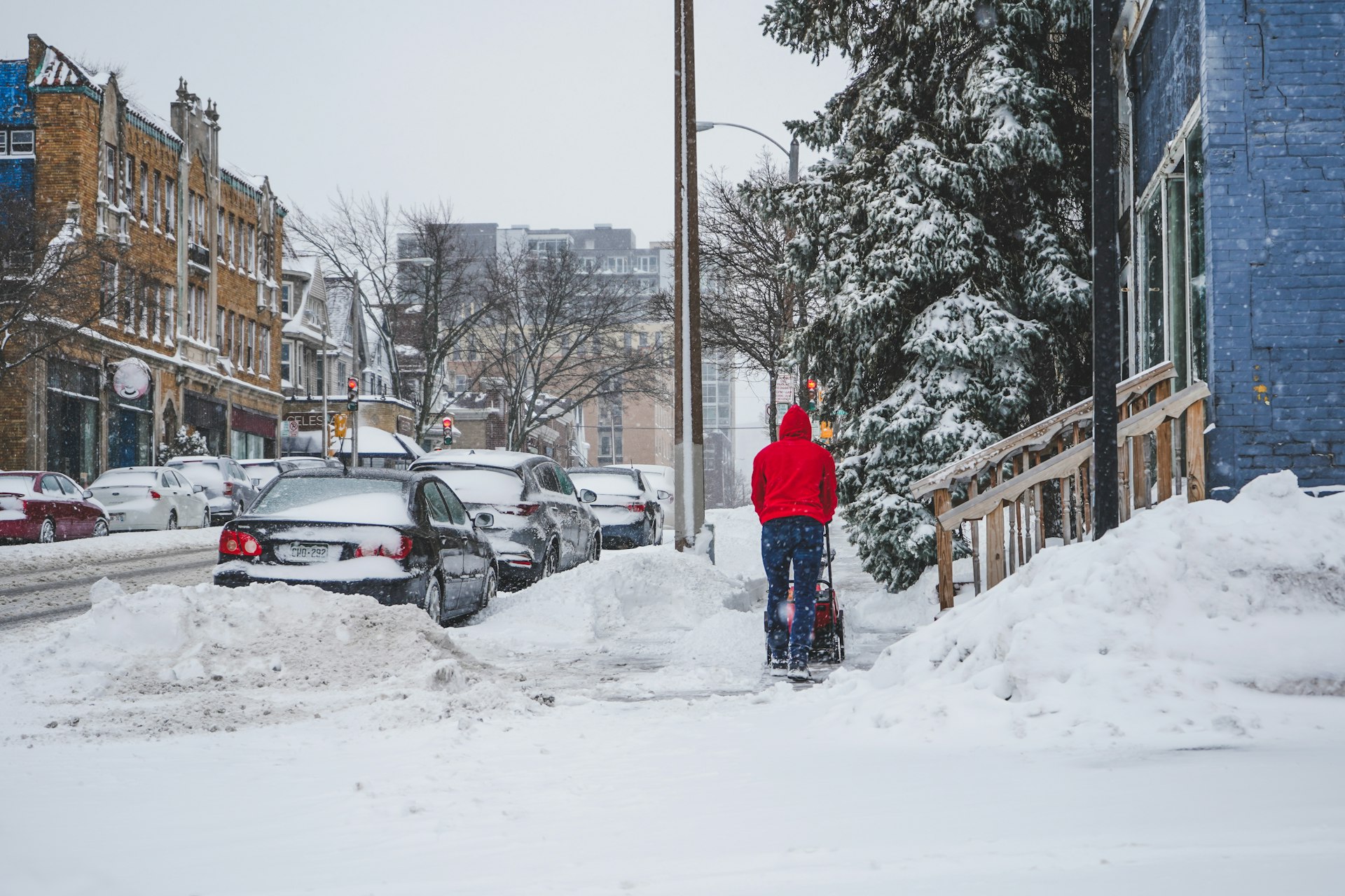 person in blue jacket standing on snow covered ground during daytime