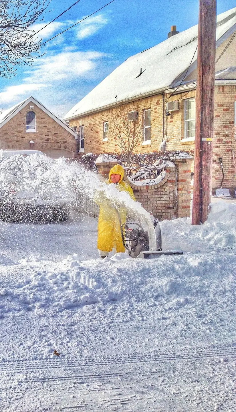 man using snow thrower